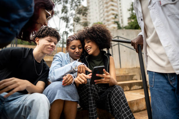 istock Friends using the mobile phone outdoors 1489220936