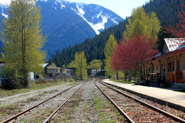 Picturesque Scenic With Railway Tracks Pemberton BC Mt Currie,Railway tracks and station Pemberton BC. partial snow. Unidentified person on side. pemberton town stock pictures, royalty-free photos & images