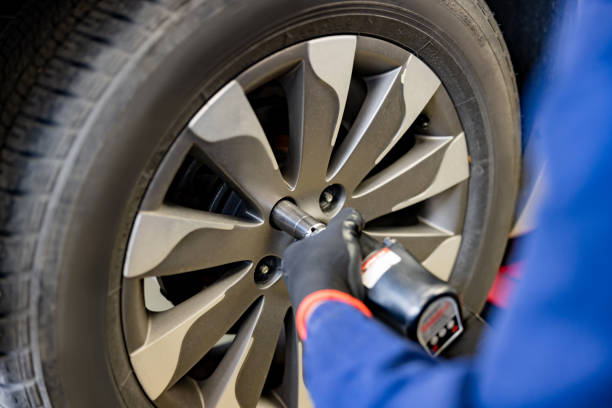 istock Mechanic changing a flat tire on a car 1489227535