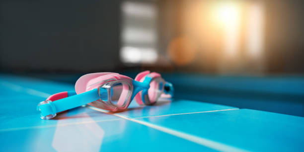 istock Swimming protection goggles lies on blue tiled pool edge 1489229619