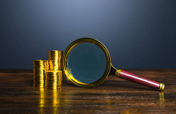 istock Money and a magnifying glass. 1489231916