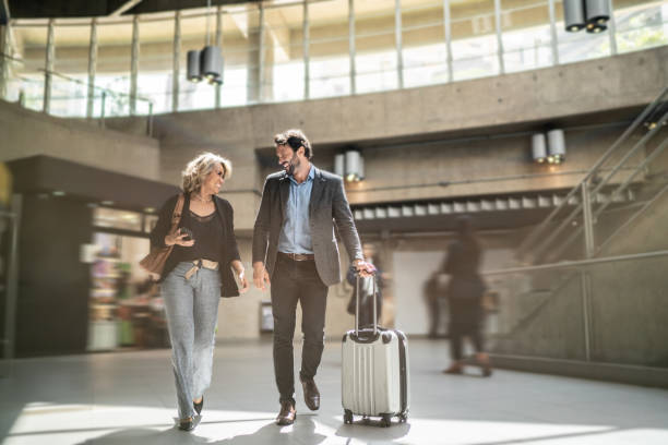 istock Coworkers talking while walking at a subway station 1489233457