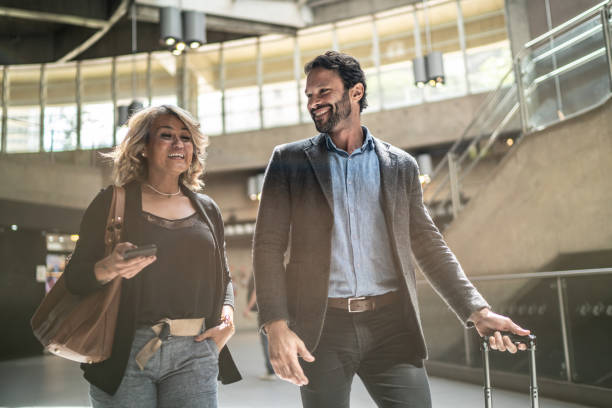 Coworkers talking while walking at a subway station