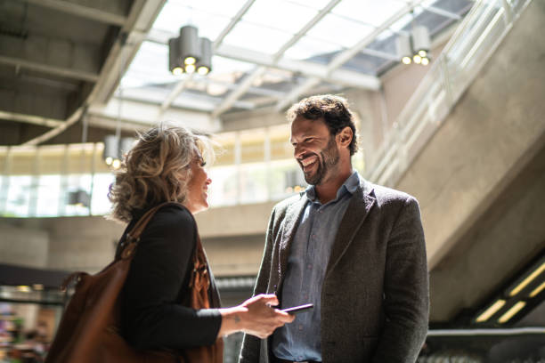 Coworkers talking at a subway station