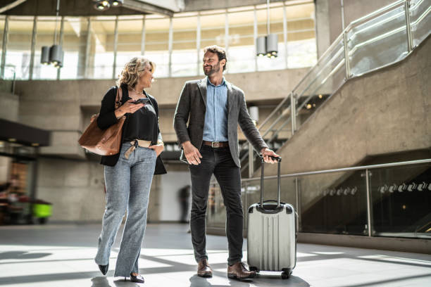 istock Coworkers talking while walking at a subway station 1489233475