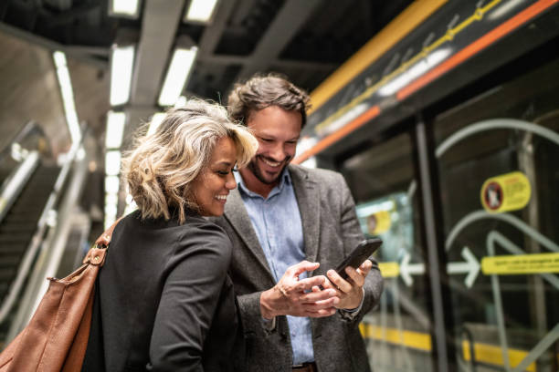 istock Coworkers using the mobile phone at a subway station 1489235068