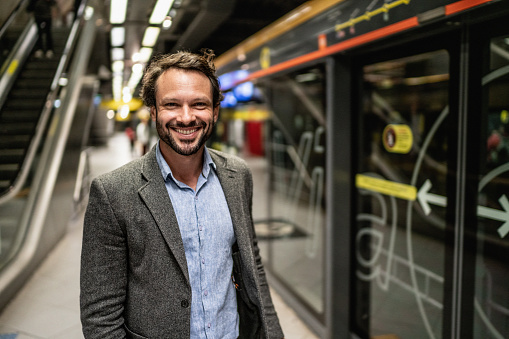 Portrait of a mature man at a subway station