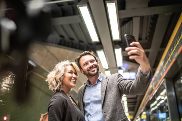 istock Coworkers taking selfies using the mobile phone at a subway station 1489235148
