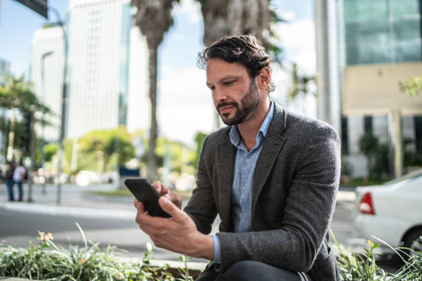 istock Mature man using the mobile phone in the street 1489235853