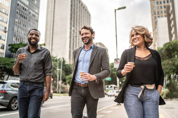 Coworkers talking while walking in the street