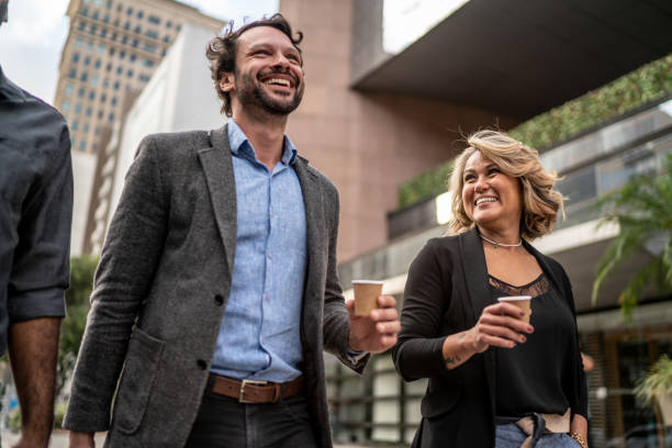 Coworkers talking while walking in the street