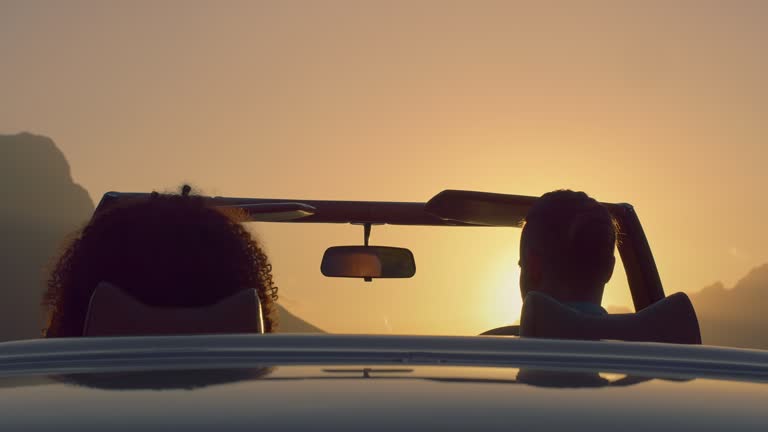 Couple, convertible car and sunset road trip in summer with mountains, mock up space or vacation. Young woman, man and nature with vehicle for transportation, holiday travel or start journey together
