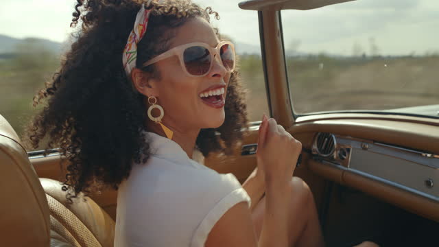 Travel, car and happy woman dancing on road trip, summer holiday or motor journey by countryside in happiness. Gen z biracial person or passenger dance with wind in hair, convertible and nature drive