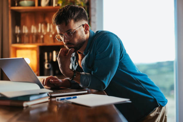 istock Man doing research on laptop at home. 1489242674