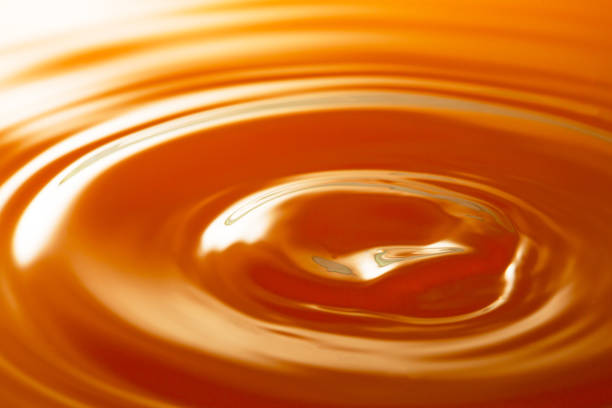 istock macro orange juice texture,Macro orange water drop texture,Falling drop in orange water with splash,The waves after a few drops of orange juice. 1489243023
