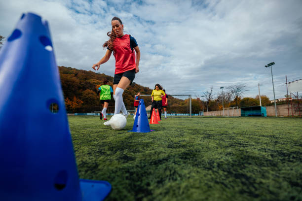 istock Female football player practicing dribbling. 1489245690