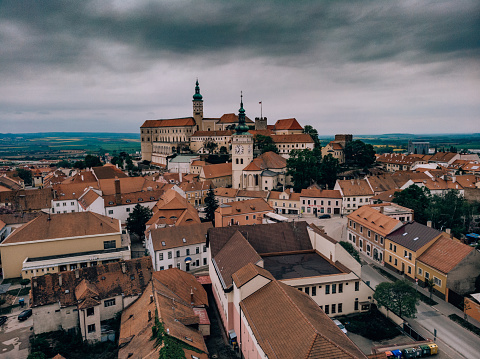 Aerial view of Mikulov, Moravia, Czech Republic. Landscape photography from drone. Old architecture, downtown district. Storm weather, clouds and sky, picture from air. Moravian region.