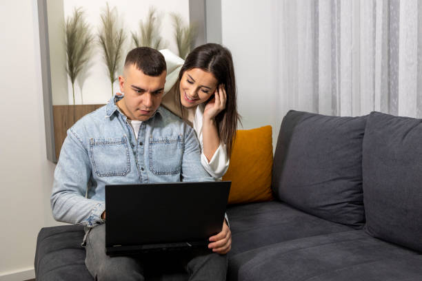 istock Young couple uses a computer and decides on a destination for a tourist trip 1489248521
