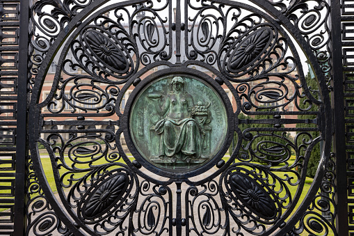 The Hague, Netherlands - April 17, 2023: Figure of Harmony (Concordia) on the black wrought iron gates of the Peace Palace in The Hague, which houses the International Court of Justice