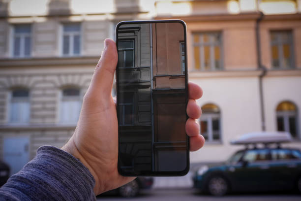 istock Cropped hand holding phone while taking photo of a building 1489249667
