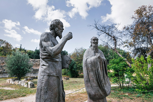 Statues of Socrates and Confucius at the ancient Agora of Athens. The Monument is situated west side of the Roman Agora, in Athens, Greece.