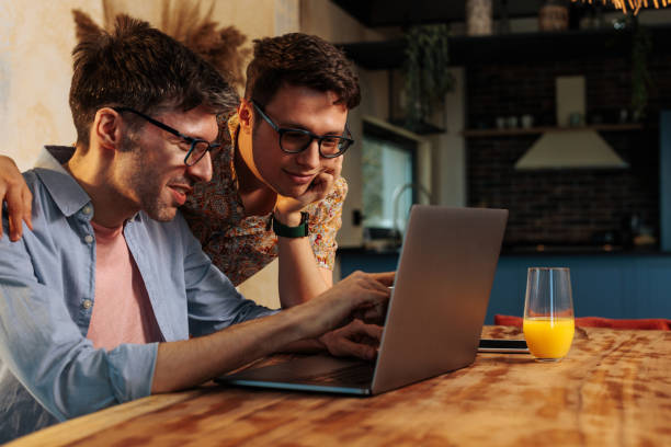 istock Same sex couple working at home. 1489251818