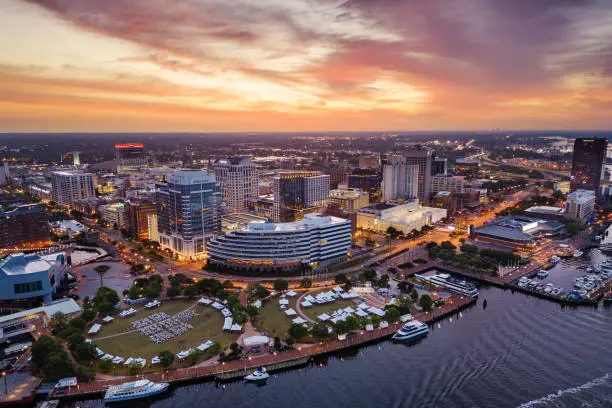 Norfolk, Virginia, USA downtown city skyline from over the Elizabeth River at dusk.