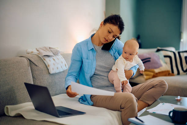 istock Multi-tasking female entrepreneur with baby working at home. 1489253397