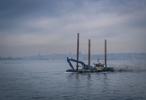 a barge carrying construction equipment at sea