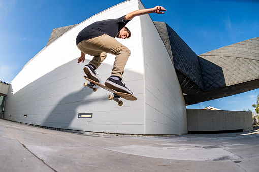 Skateboarder doing nollie trick on a urban scene.