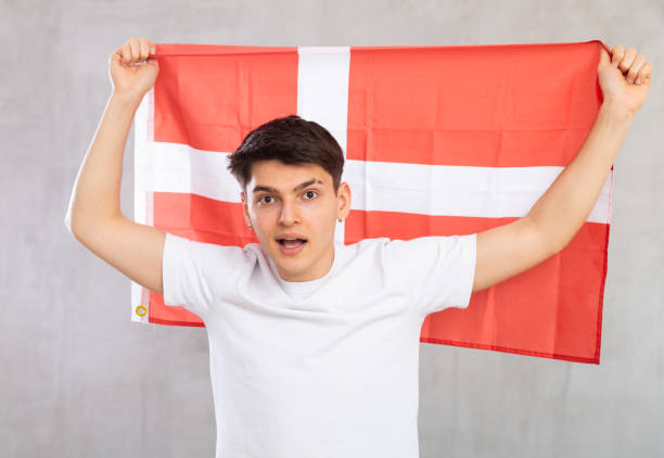 istock Surprised young guy holding flag of Denmark 1489259592