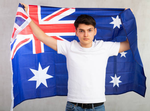 istock Focused young guy holding flag of Australia 1489259831