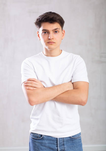 istock Confident young man posing against background of grey unicolored wall 1489260423