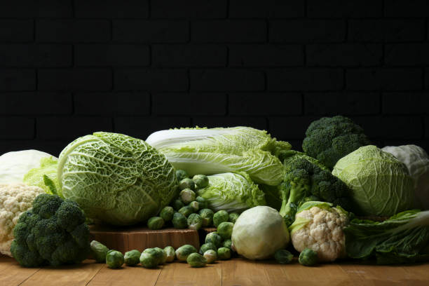 istock Many different types of fresh cabbage on wooden table near brick wall 1489261765