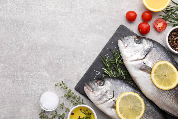 istock Flat lay composition with fresh raw dorado fish and ingredients on light grey table, space for text 1489261793
