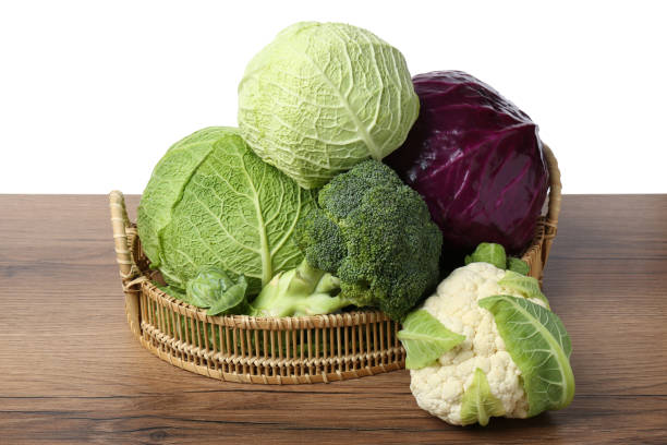 istock Wicker tray with different types of fresh cabbage on wooden table against white background 1489262059