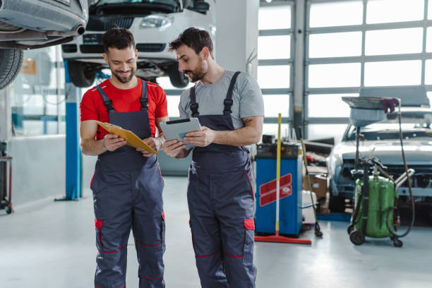 istock Mechanics working at car service 1489262750