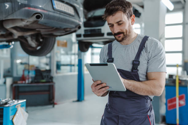 istock Automotive technician at the service station checking tasks on a digital tablet 1489262812
