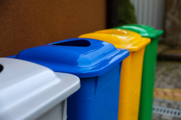 istock Many color recycling bins near brown wall outdoors, closeup. Space for text 1489263476