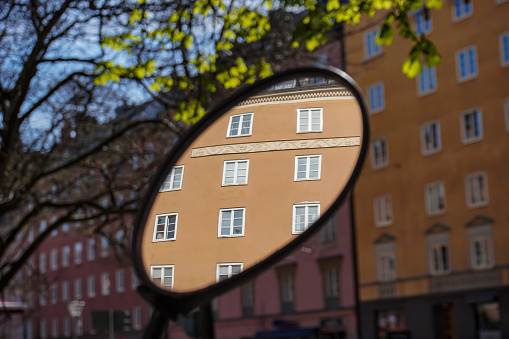 close-up of a rear view mirror against buildings in city