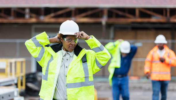 istock African-American woman, construction workers put on gear 1489266476