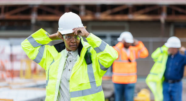 istock African-American woman, construction workers put on gear 1489266477