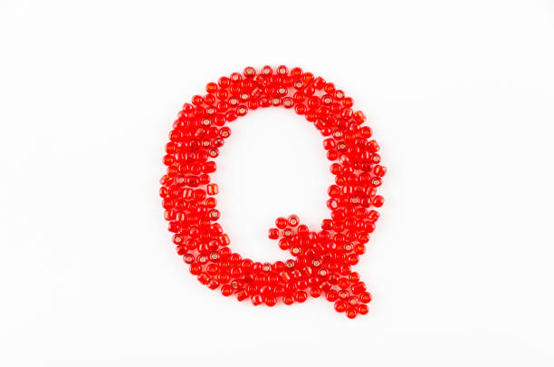 Alphabet of red beads on white background Q
