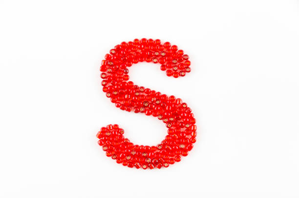 Alphabet of red beads on white background S