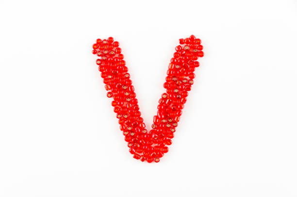 Alphabet of red beads on white background V