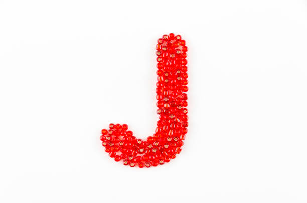 Alphabet of red beads on white background J