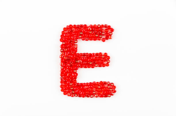 Alphabet of red beads on white background E