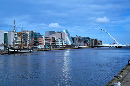 Dublin - March 2023: View of the River Liffey in Dublin with modern buildings near the restored docklands area