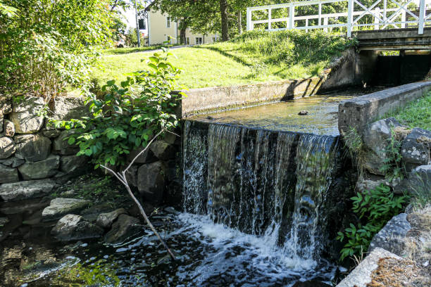 istock A white bridge over a small waterfall in park 1489277541