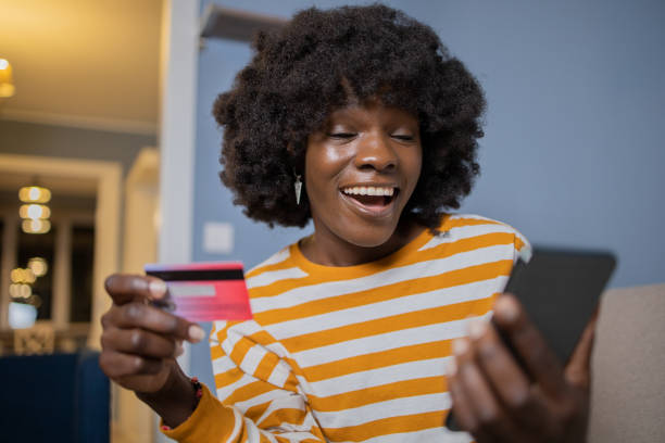 istock Cheerful  woman doing online shopping 1489277826